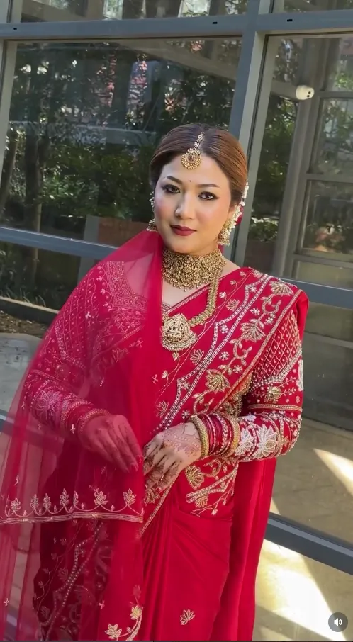 Bride in a deep red lehenga with traditional jewellery