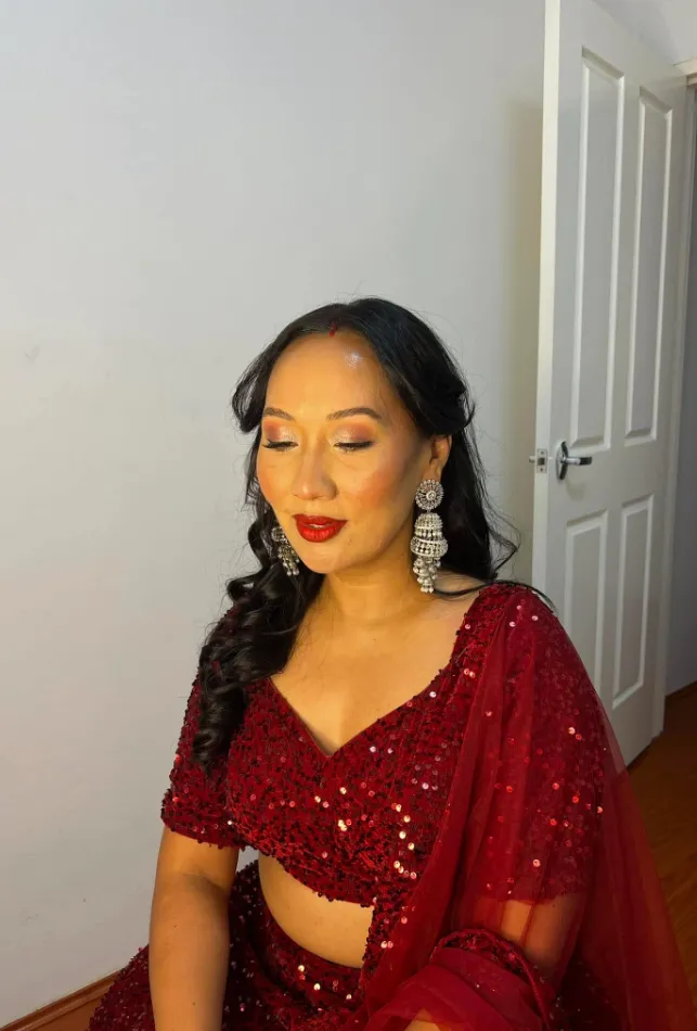 Bridal makeup and hair with a red sequin saree and red lip