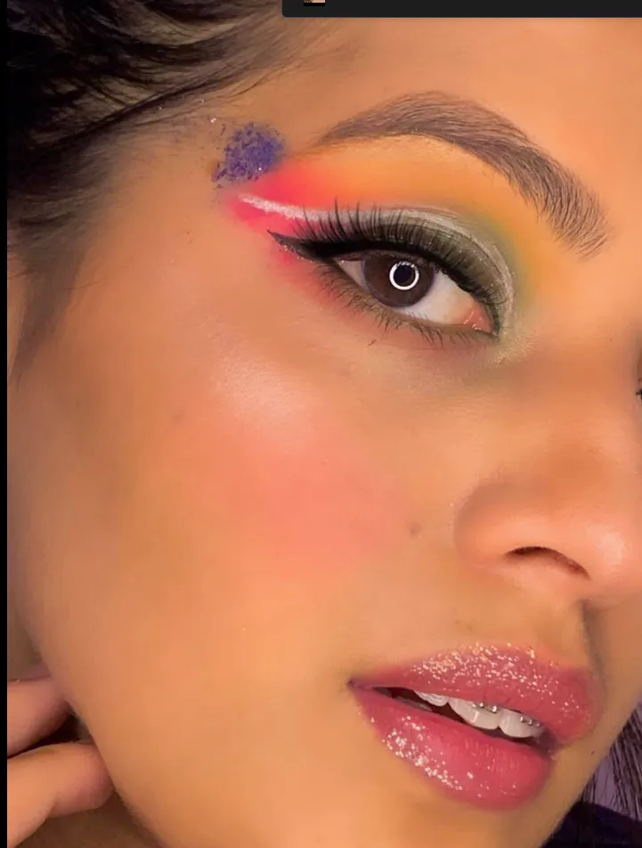 Vibrant coral and gold eyeshadow detail